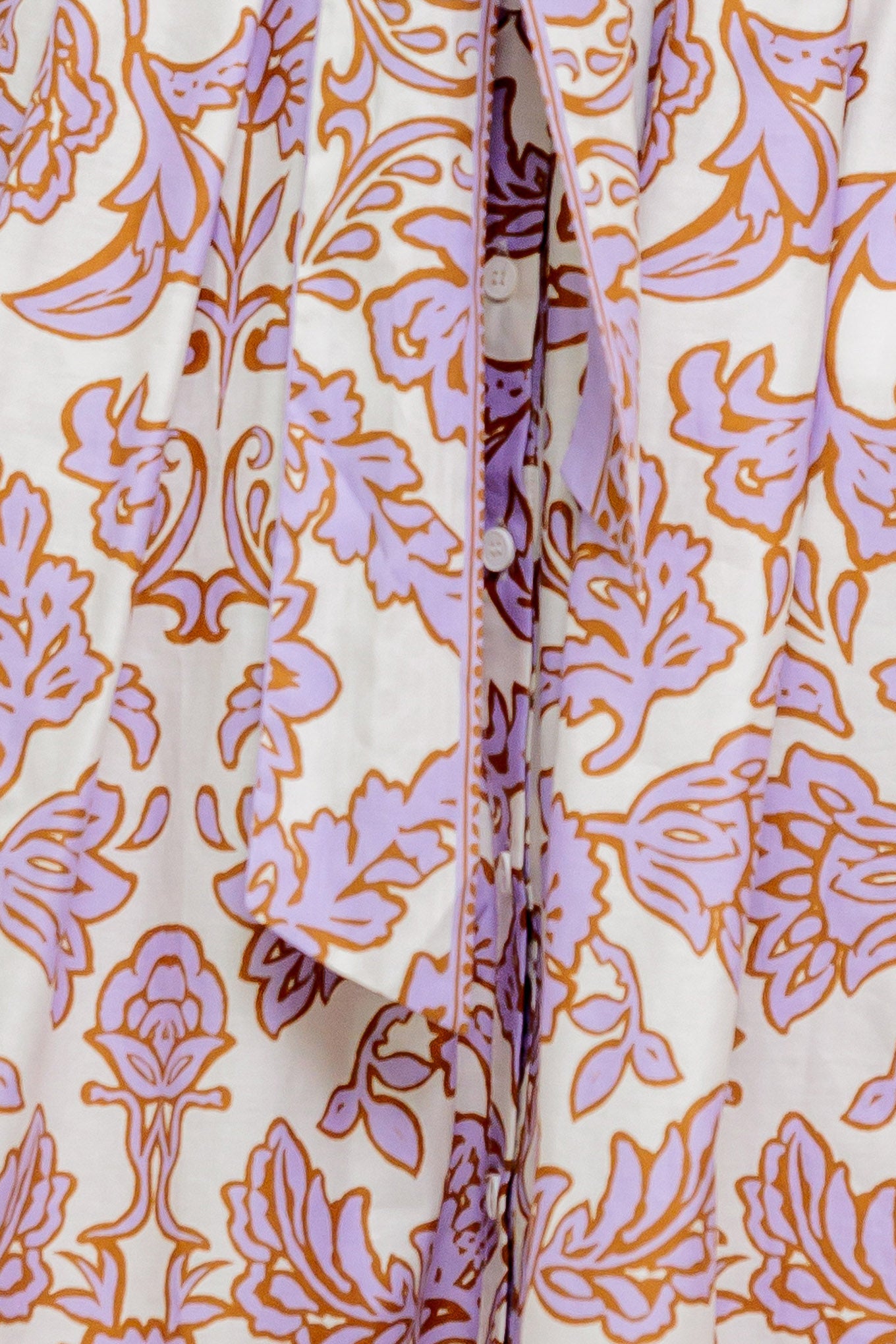 A printed woven mini dress featuring collar, short sleeve, button down, self sash tie and full skirt