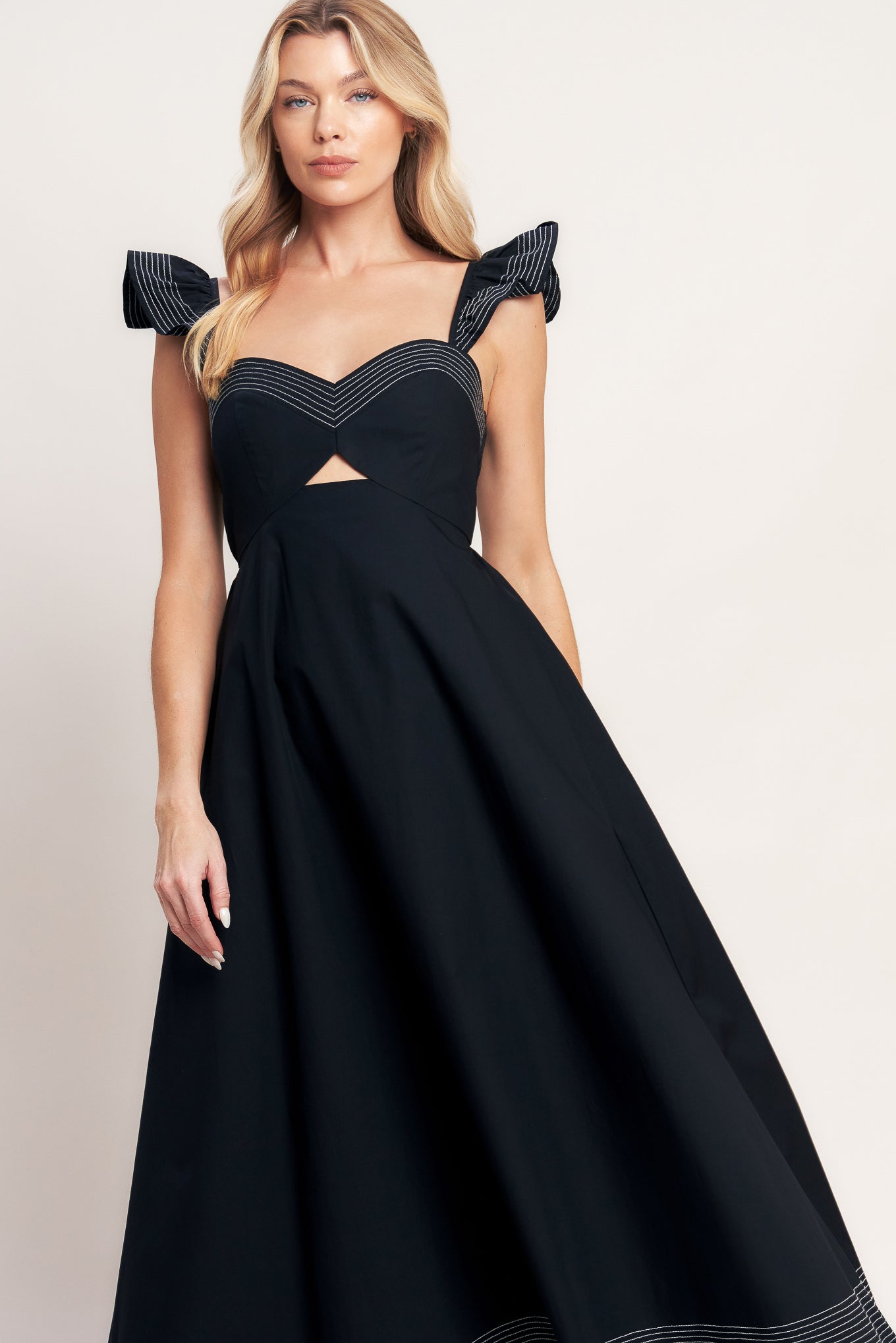 A solid woven midi dress featuring sweetheart neckline, flutter sleeve, center front cut out, circle skirt and smocked back bodice

Details:

Self: 100% Cotton

Size & Fit

-Model is 5`8" And Wearing Size Small
-Measurements Taken From Size Small
-Approx. Length: 51"