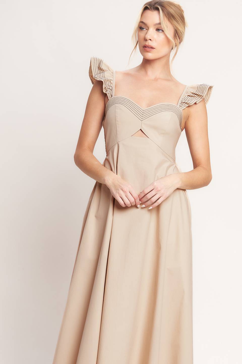 A solid woven midi dress featuring sweetheart neckline, flutter sleeve, center front cut out, circle skirt and smocked back bodice

Details:

Self: 100% Cotton

Size & Fit

-Model is 5`8" And Wearing Size Small
-Measurements Taken From Size Small
-Approx. Length: 51"