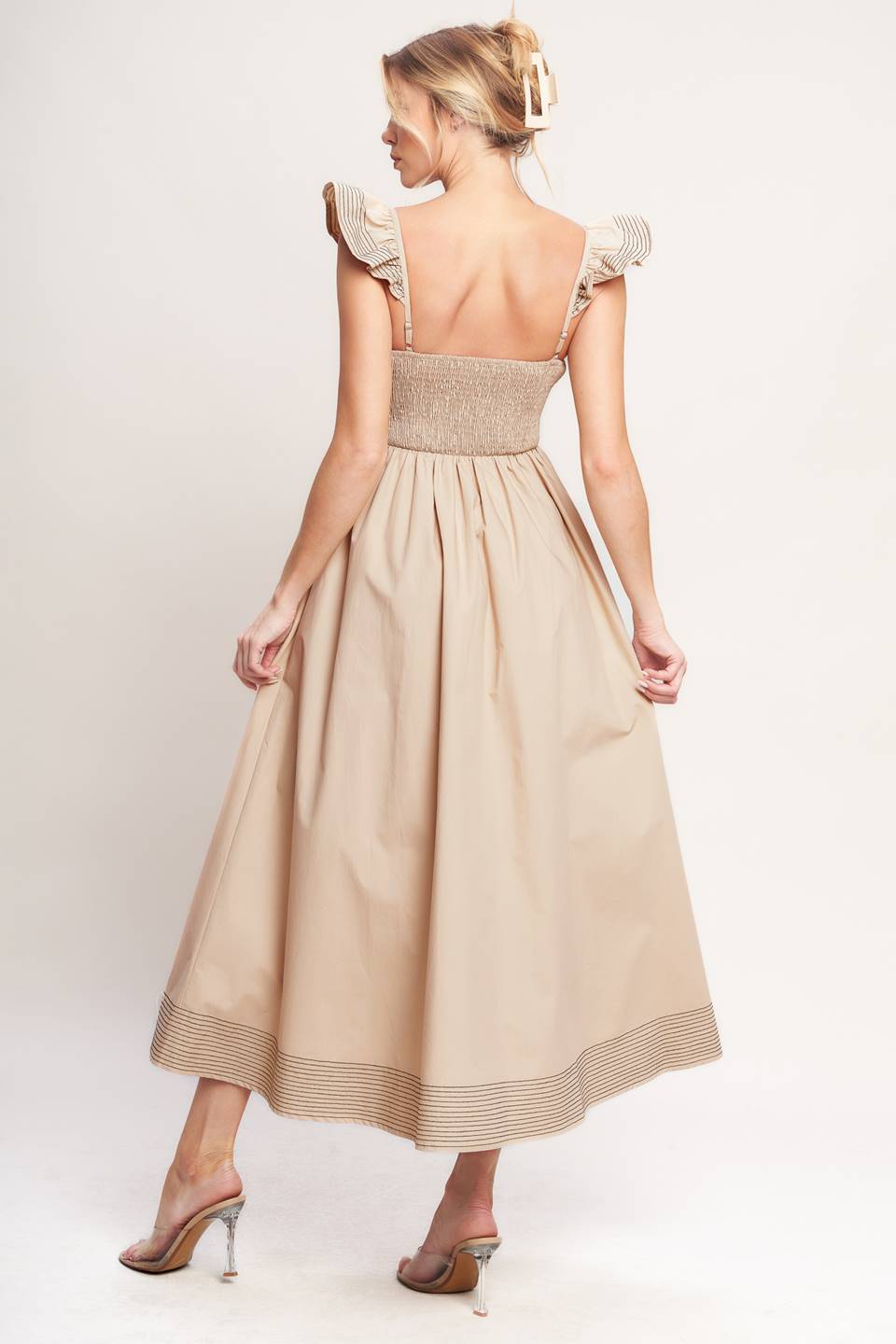 A solid woven midi dress featuring sweetheart neckline, flutter sleeve, center front cut out, circle skirt and smocked back bodice

Details:

Self: 100% Cotton

Size & Fit

-Model is 5`8" And Wearing Size Small
-Measurements Taken From Size Small
-Approx. Length: 51"