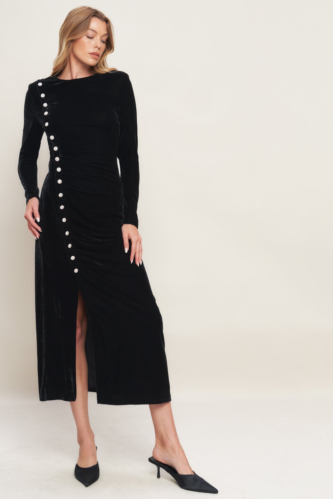 A solid velvet midi dress featuring round neckline long sleeve, side pearl button down and back zipper closure