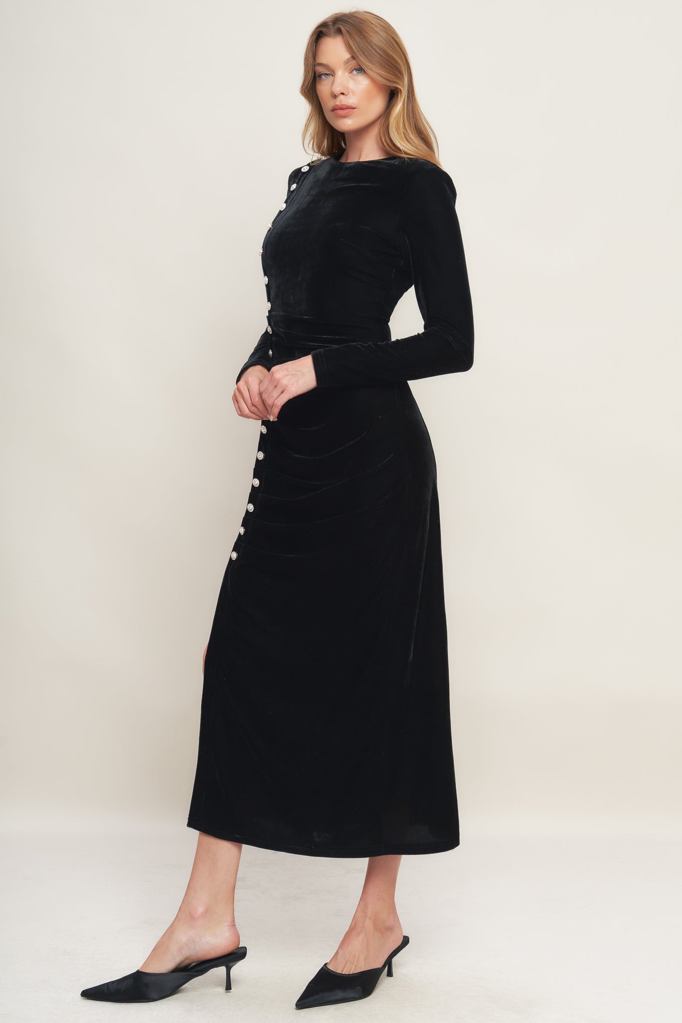 A solid velvet midi dress featuring round neckline long sleeve, side pearl button down and back zipper closure
