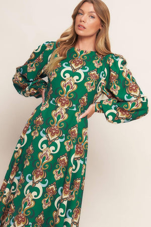 
A printed woven midi dress featuring round neckline, long sleeve with cuff, circle skirt, back cut out with tie and zipper closure
