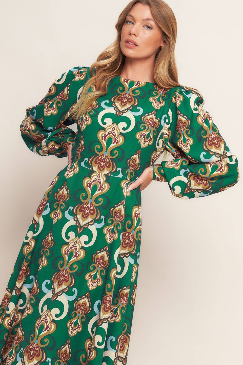
A printed woven midi dress featuring round neckline, long sleeve with cuff, circle skirt, back cut out with tie and zipper closure