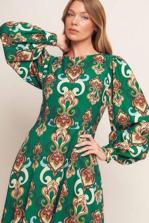 
A printed woven midi dress featuring round neckline, long sleeve with cuff, circle skirt, back cut out with tie and zipper closure