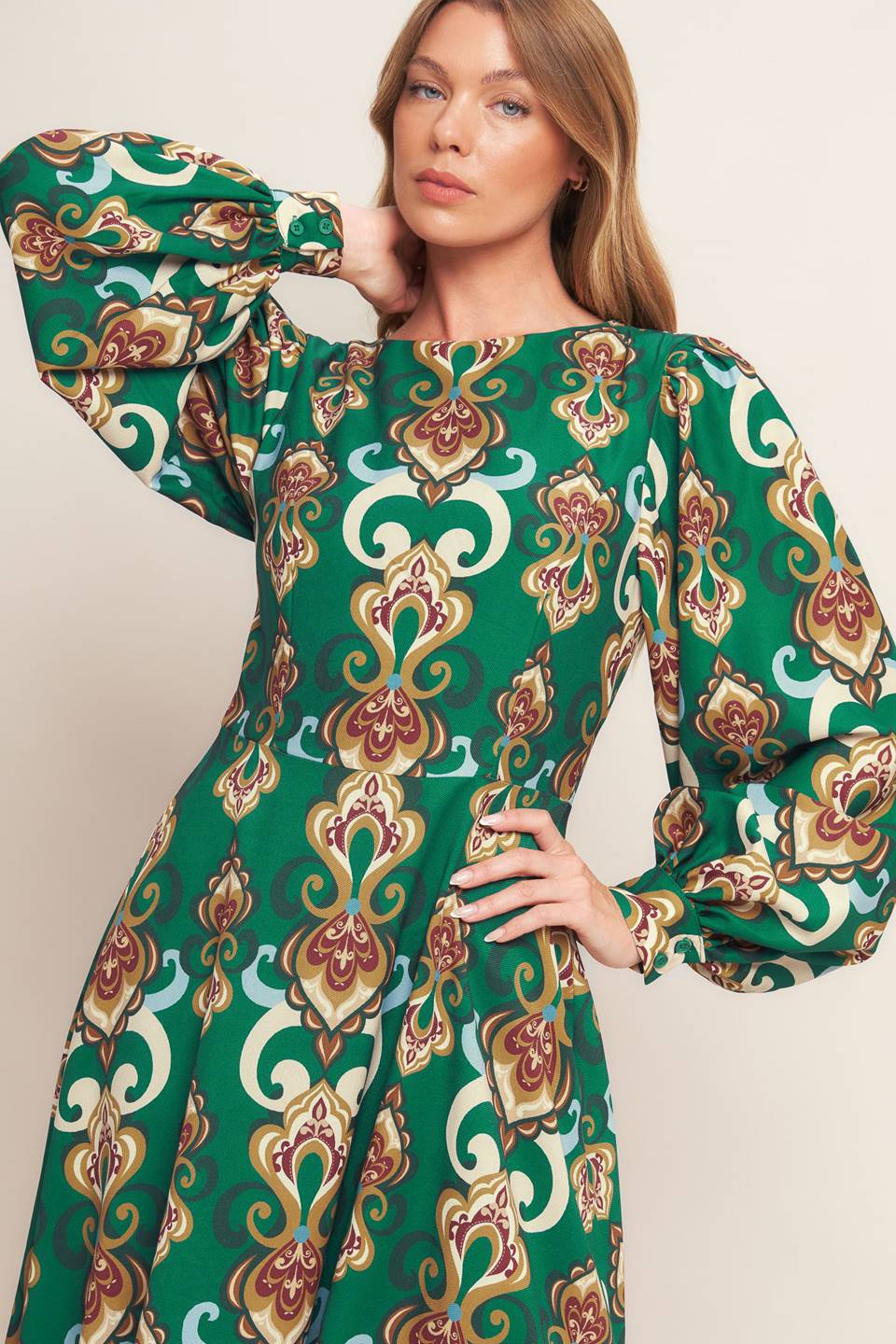 
A printed woven midi dress featuring round neckline, long sleeve with cuff, circle skirt, back cut out with tie and zipper closure