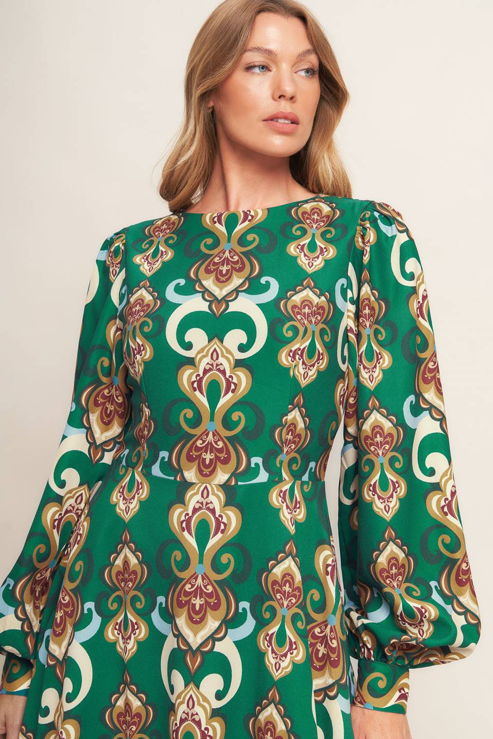 
A printed woven midi dress featuring round neckline, long sleeve with cuff, circle skirt, back cut out with tie and zipper closure