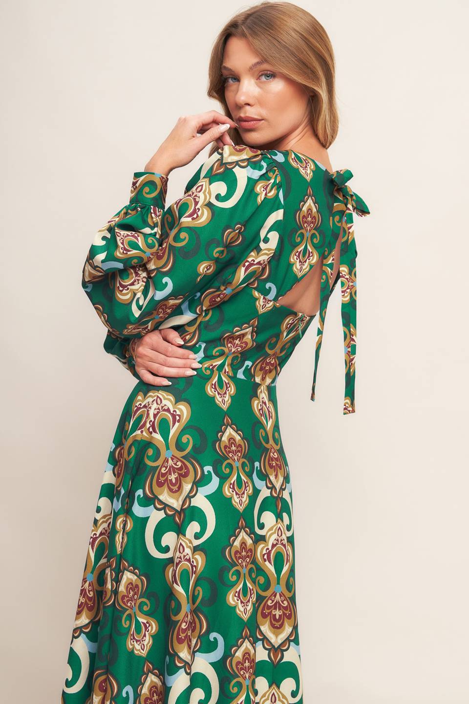 
A printed woven midi dress featuring round neckline, long sleeve with cuff, circle skirt, back cut out with tie and zipper closure
