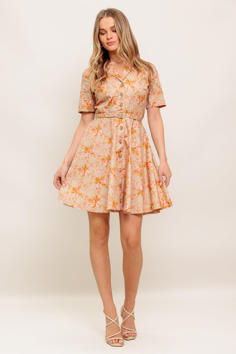A printed woven mini dress featuring collar, button down, short sleeve, self belt and circle skirt