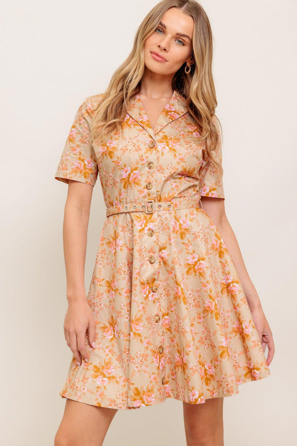 A printed woven mini dress featuring collar, button down, short sleeve, self belt and circle skirt