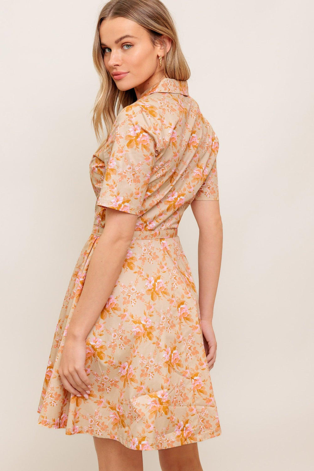 A printed woven mini dress featuring collar, button down, short sleeve, self belt and circle skirt
