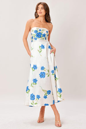 Woman wearing a strapless floral printed woven midi dress featuring strapless, circle skirt and back zipper closure 