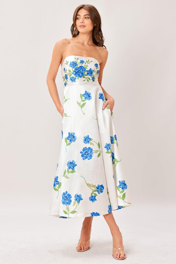 Woman wearing a strapless floral printed woven midi dress featuring strapless, circle skirt and back zipper closure 