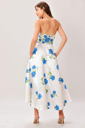Woman wearing a strapless floral printed woven midi dress featuring strapless, circle skirt and back zipper closure 