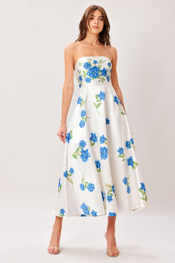 Woman wearing a strapless floral printed woven midi dress featuring strapless, circle skirt and back zipper closure 