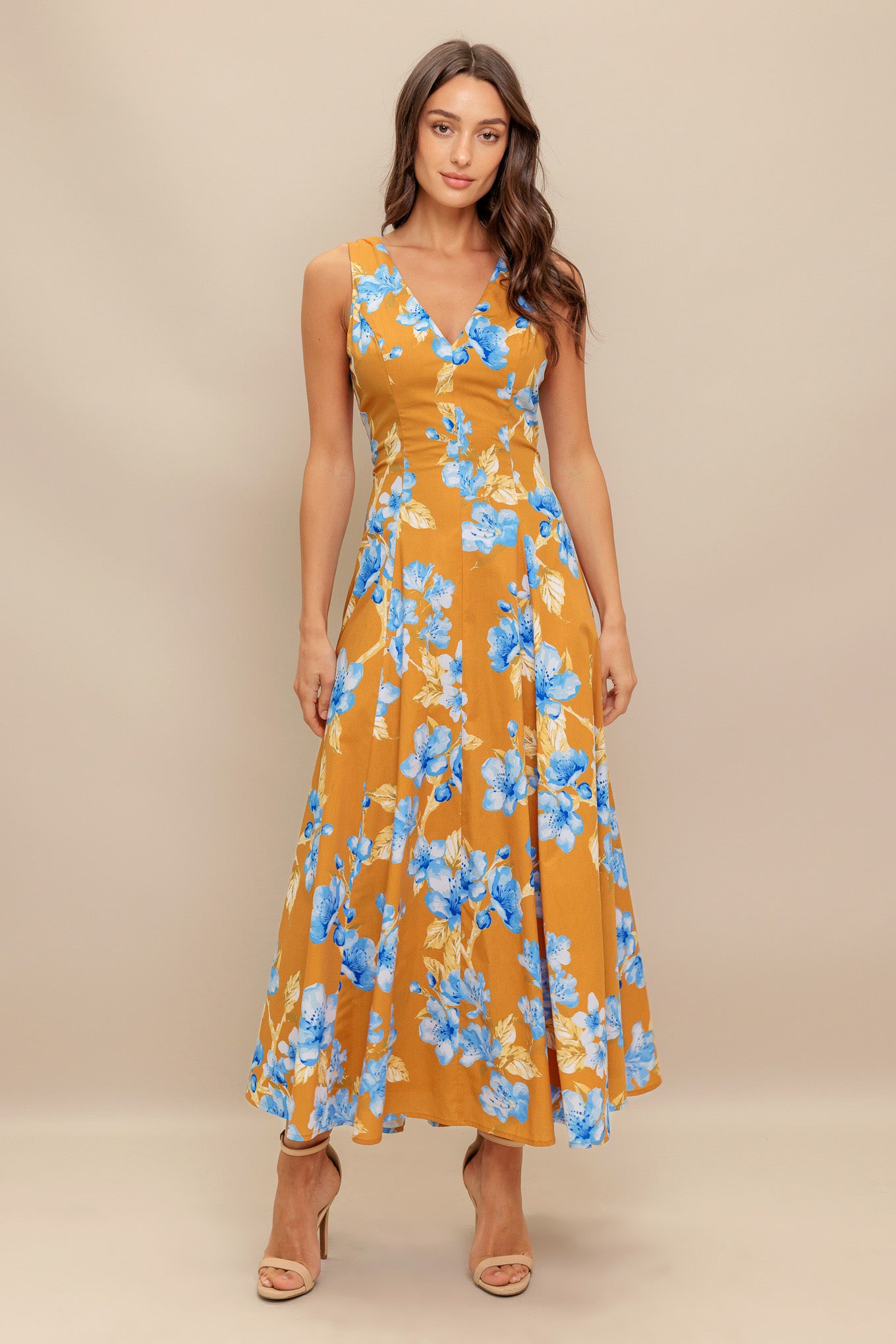 A printed woven midi dress featuring V neckline, sleeveless, circle skirt and back zipper closure