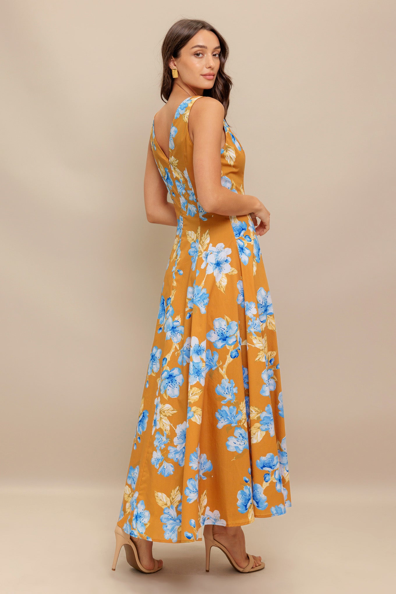 A printed woven midi dress featuring V neckline, sleeveless, circle skirt and back zipper closure