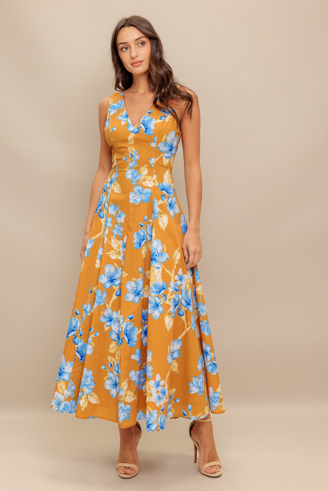 A printed woven midi dress featuring V neckline, sleeveless, circle skirt and back zipper closure