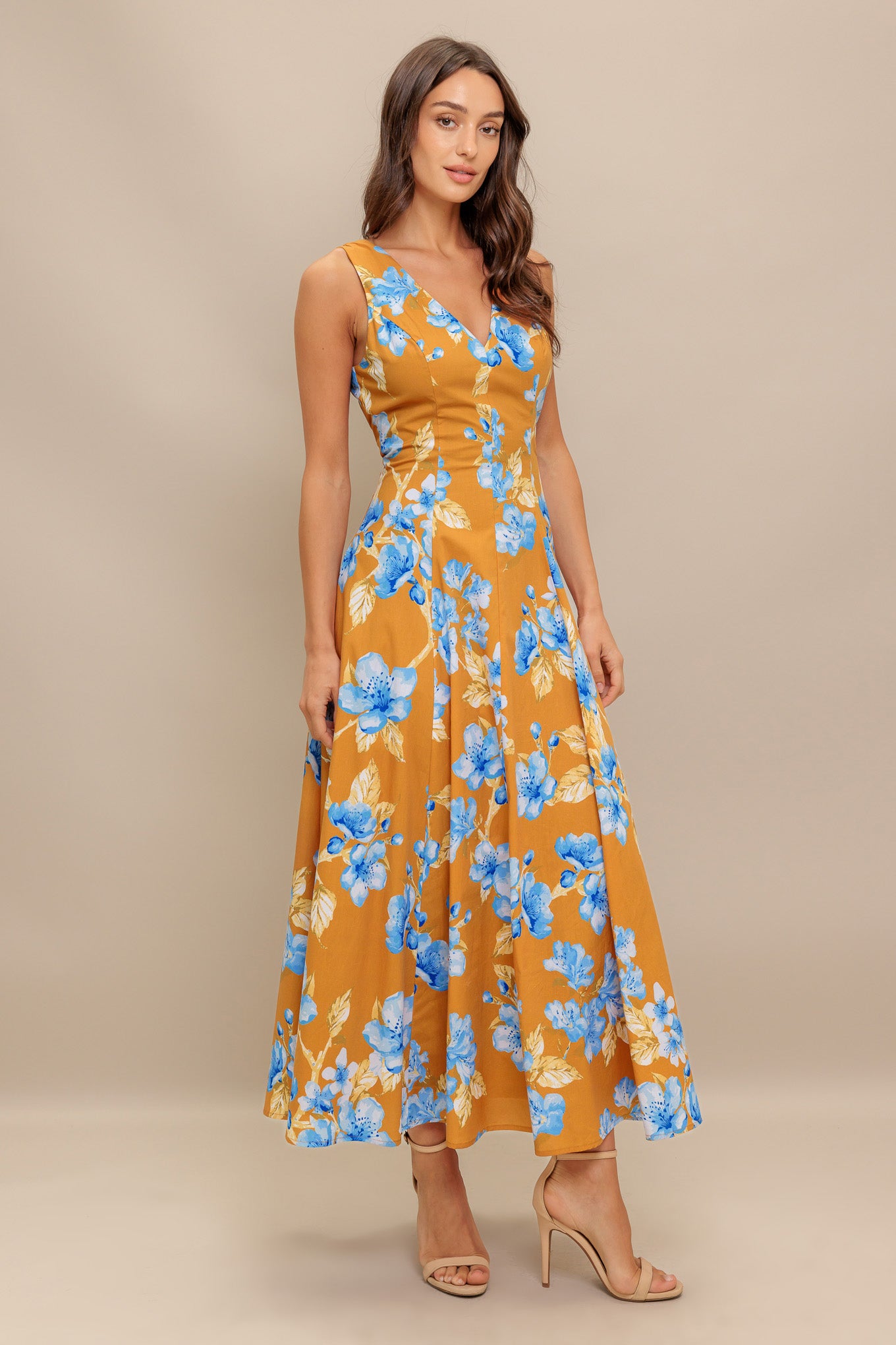 A printed woven midi dress featuring V neckline, sleeveless, circle skirt and back zipper closure