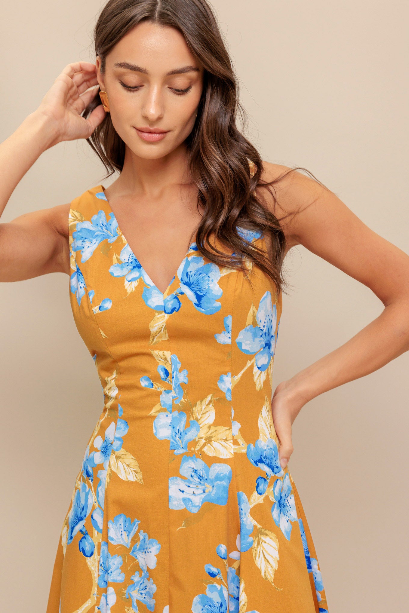 A printed woven midi dress featuring V neckline, sleeveless, circle skirt and back zipper closure