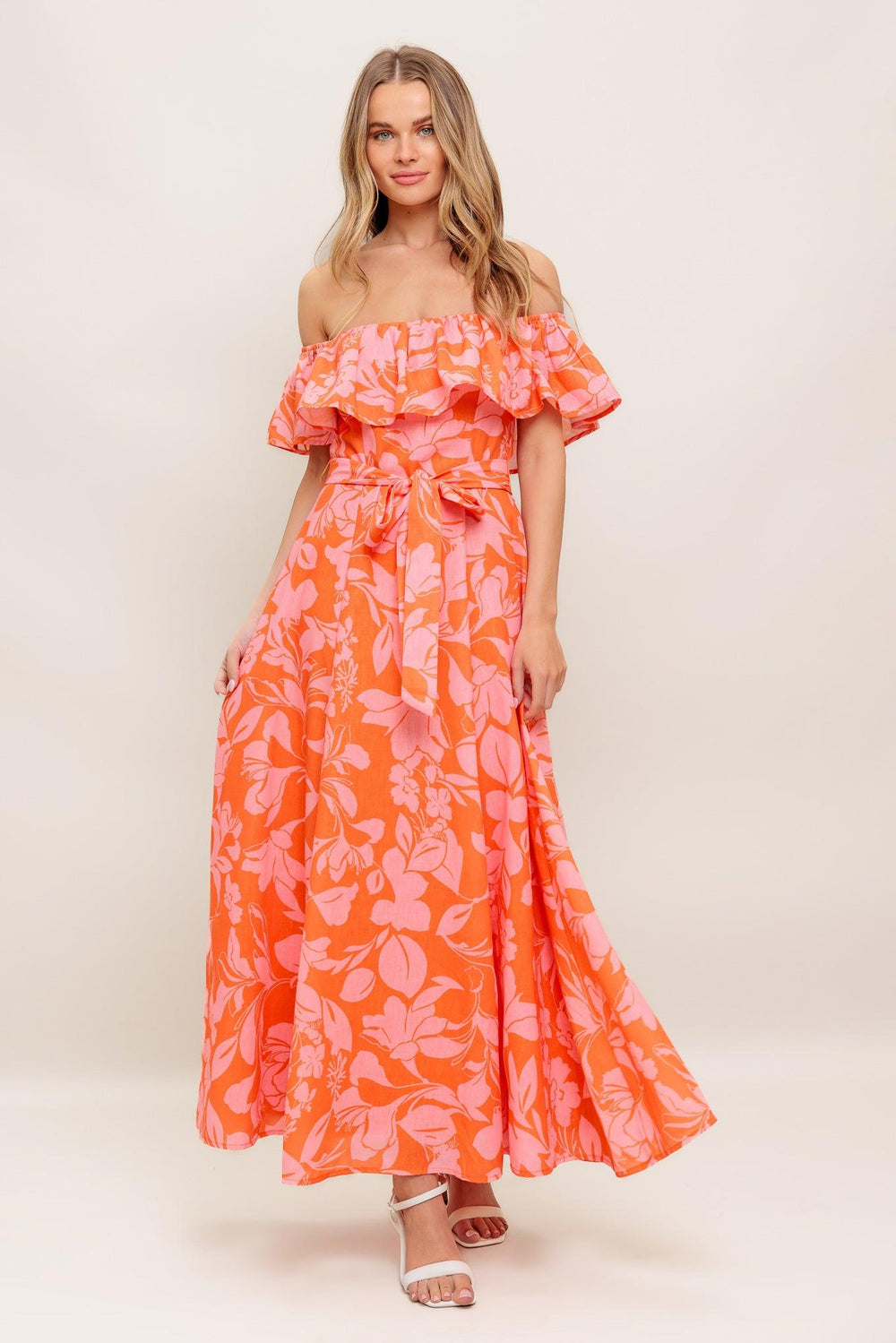 A printed woven midi dress featuring off shoulder neckline with flounce, self sash tie, circle skirt and back zipper closure