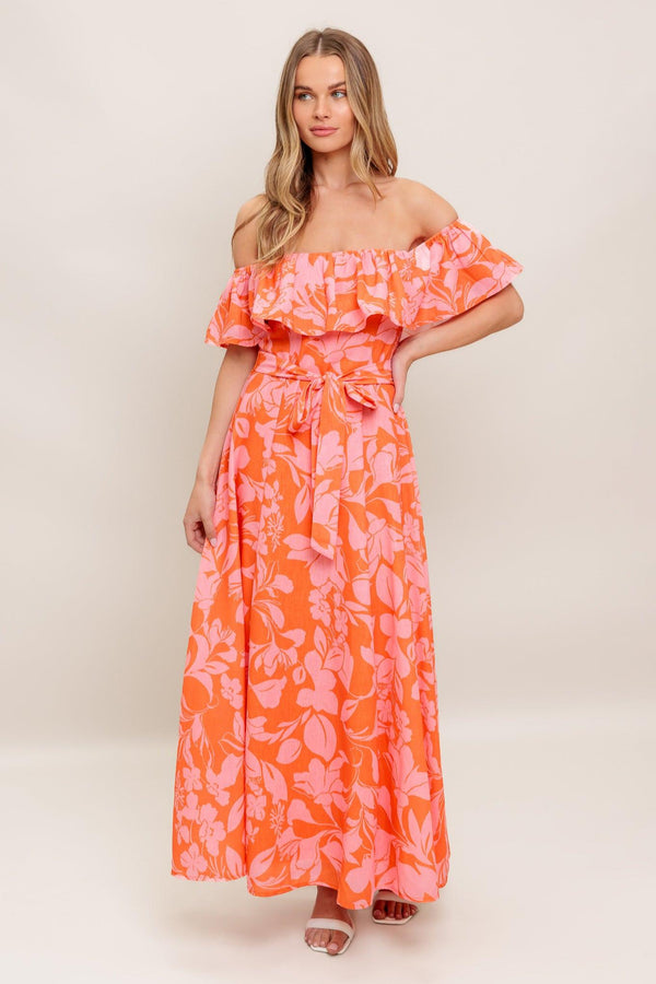 A printed woven midi dress featuring off shoulder neckline with flounce, self sash tie, circle skirt and back zipper closure