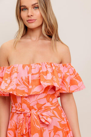A printed woven midi dress featuring off shoulder neckline with flounce, self sash tie, circle skirt and back zipper closure