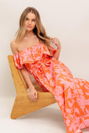 A printed woven midi dress featuring off shoulder neckline with flounce, self sash tie, circle skirt and back zipper closure