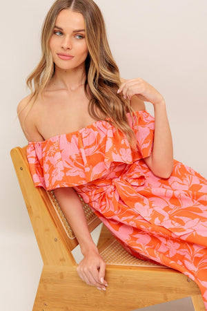 A printed woven midi dress featuring off shoulder neckline with flounce, self sash tie, circle skirt and back zipper closure