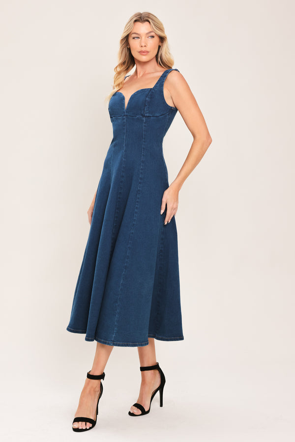 Woman wearing a sleeveless indigo denim midi dress featuring sweetheart neckline, circle skirt and back zipper closure | Flying Tomato