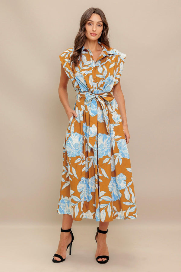 A printed woven midi dress featuring collar, short sleeve, front button down, self sash tie and full skirt
