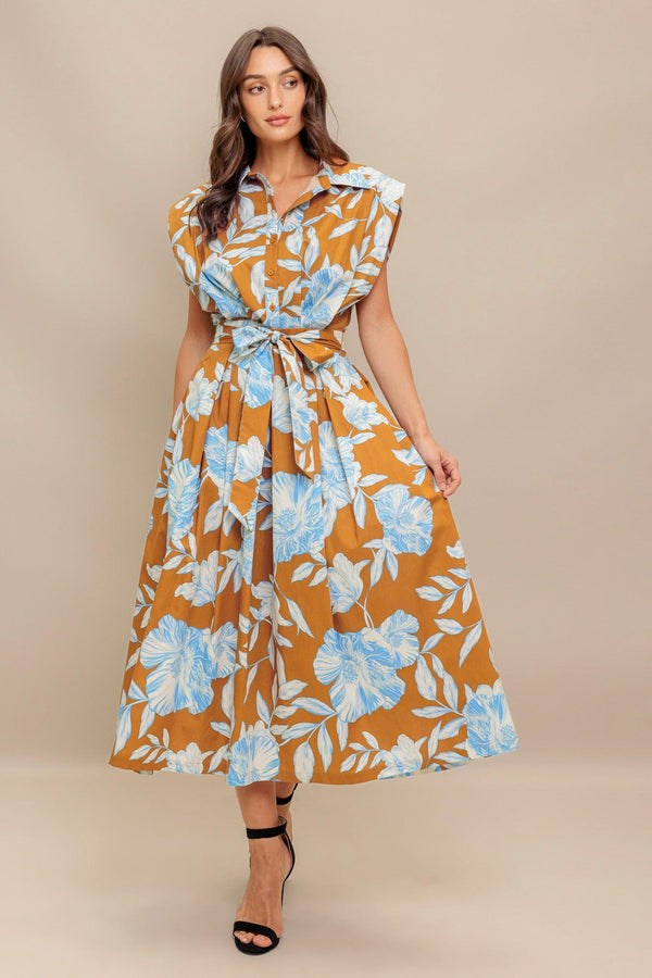 A printed woven midi dress featuring collar, short sleeve, front button down, self sash tie and full skirt