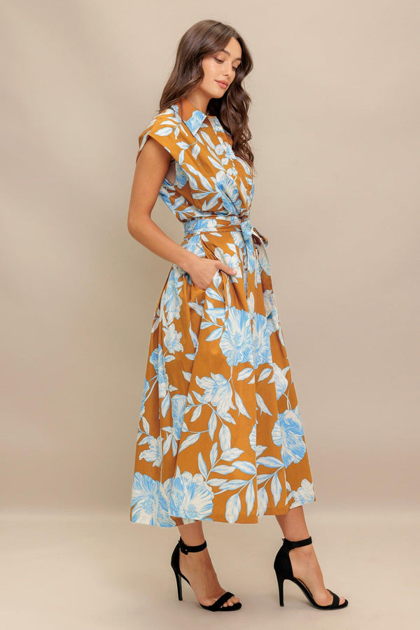 A printed woven midi dress featuring collar, short sleeve, front button down, self sash tie and full skirt