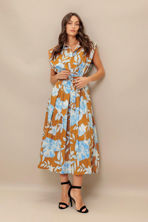 A printed woven midi dress featuring collar, short sleeve, front button down, self sash tie and full skirt