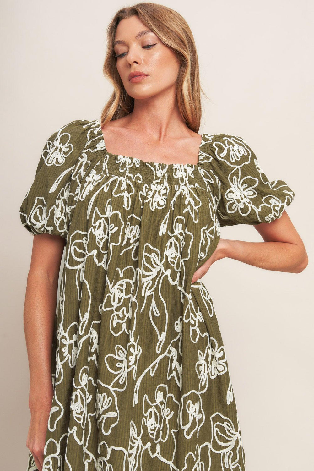 A textured woven mini dress with square neckline and short sleeve