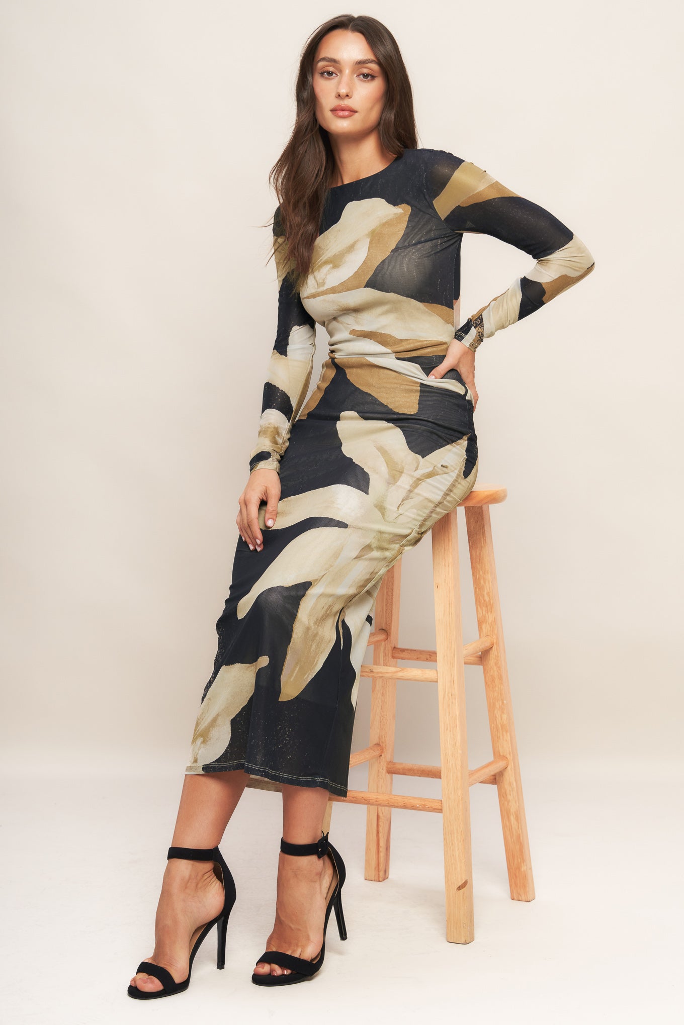 A printed power mesh midi dress featuring round neckline, long sleeve and back neck button closure