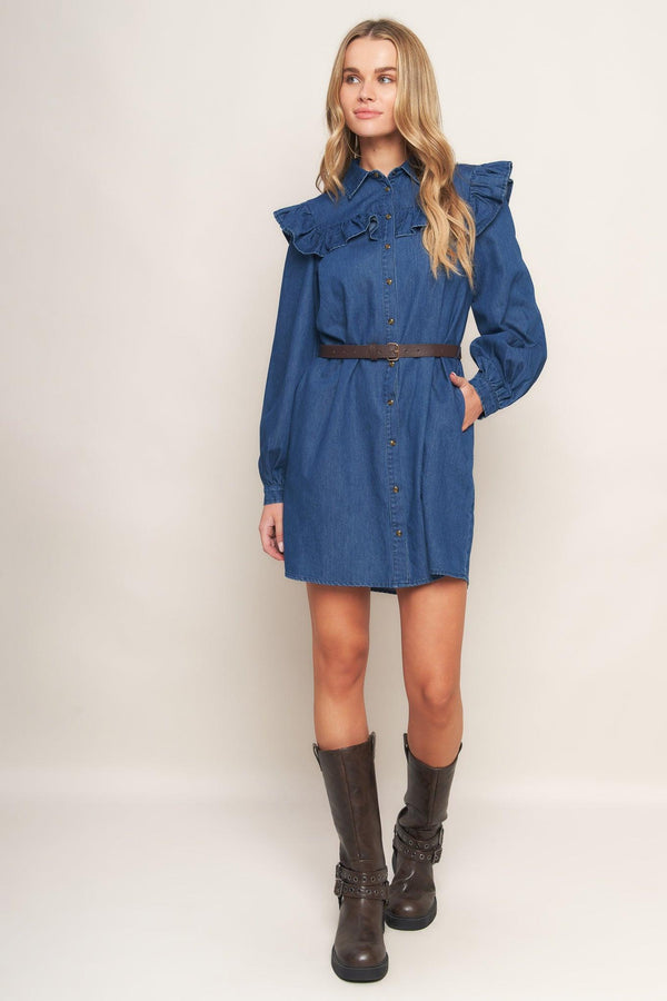 A denim mini dress featuring collar, square yoke with ruffles, long sleeve, front button down and contrasting belt