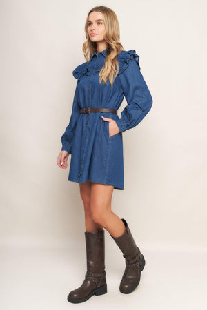 A denim mini dress featuring collar, square yoke with ruffles, long sleeve, front button down and contrasting belt