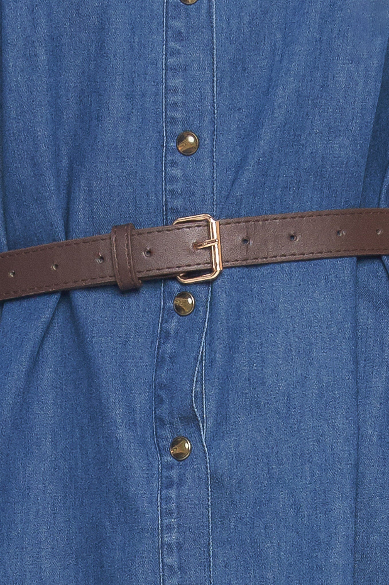 A denim mini dress featuring collar, square yoke with ruffles, long sleeve, front button down and contrasting belt