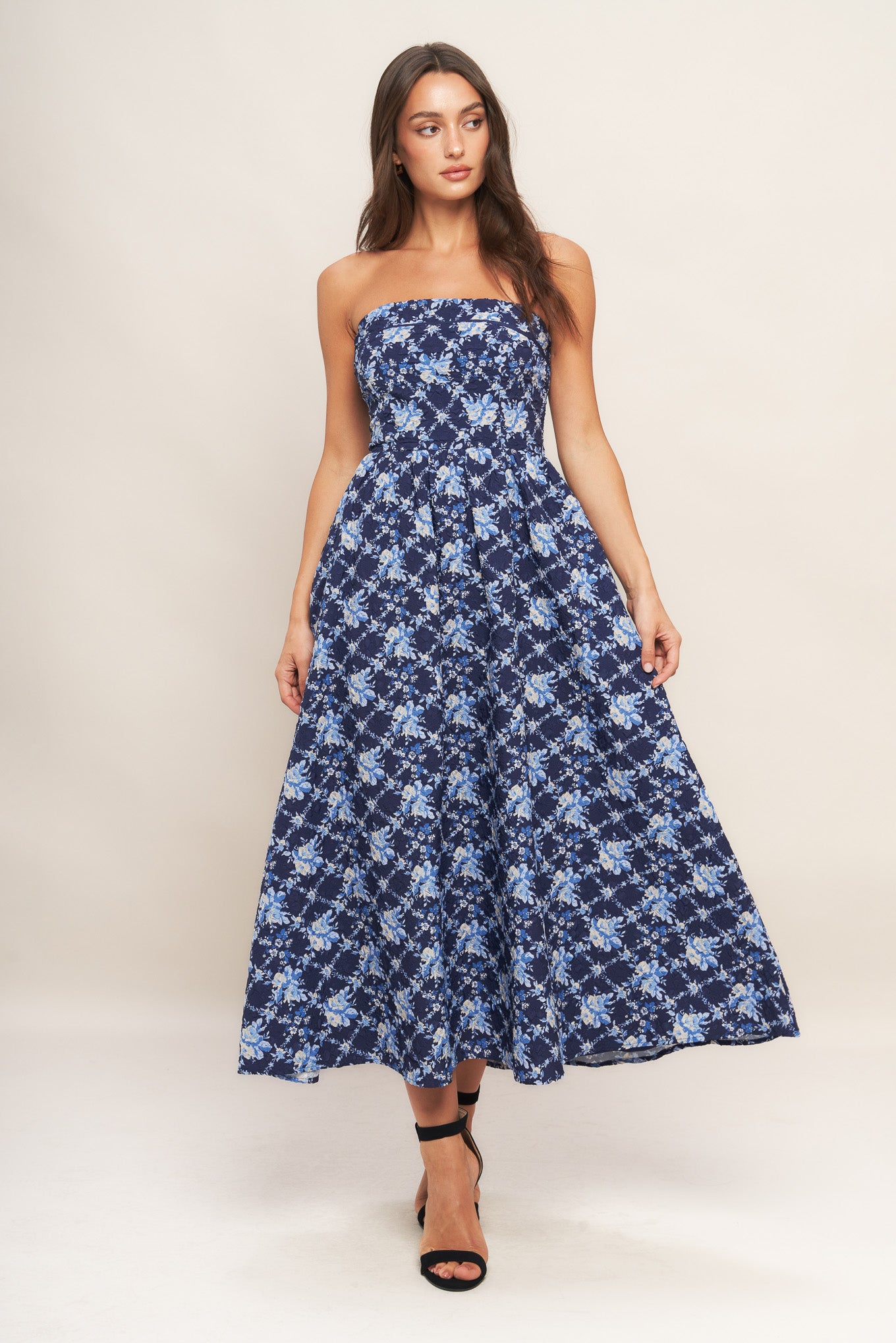 A textured woven midi dress featuring strapless, full skirt and smocked back bodices