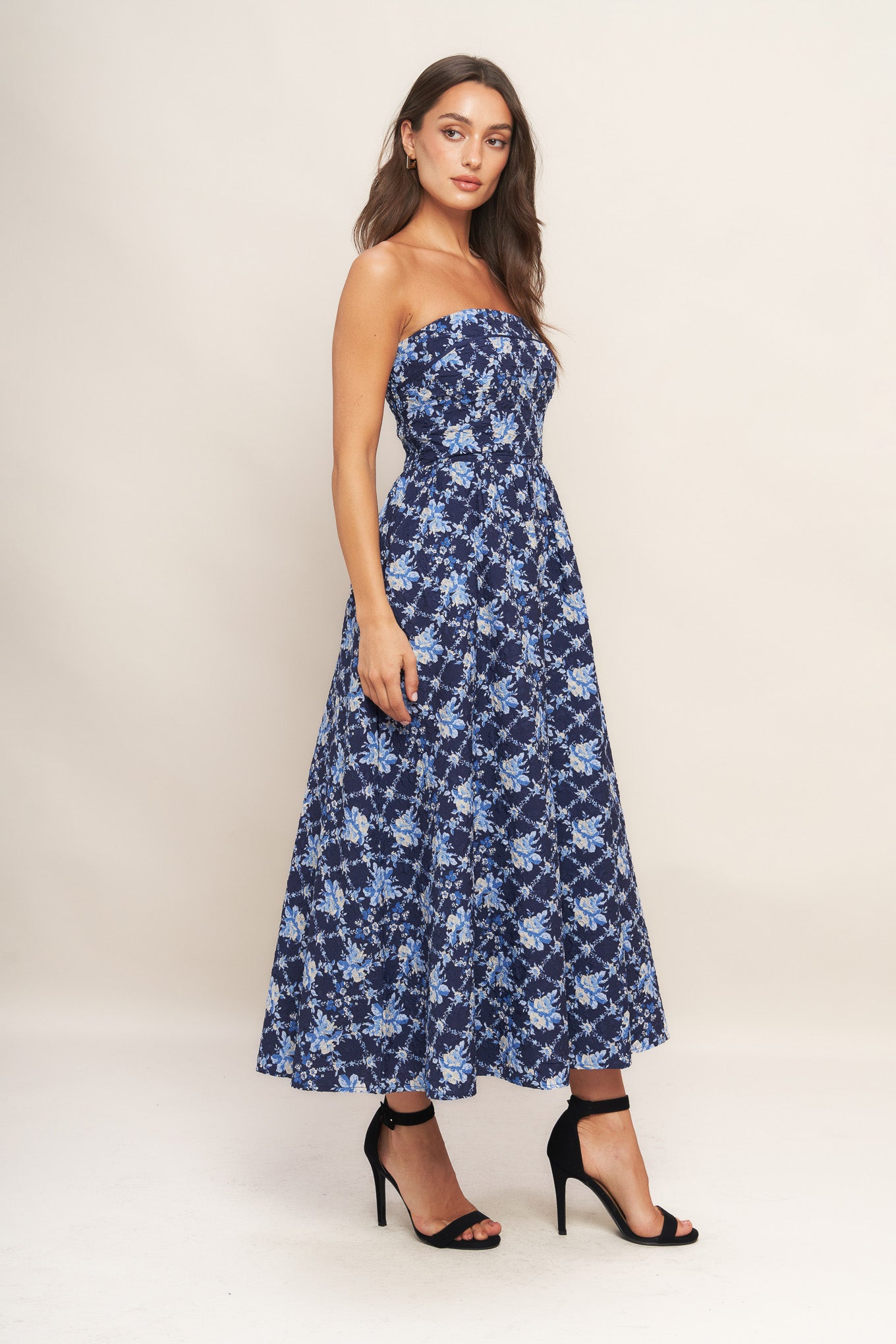 A textured woven midi dress featuring strapless, full skirt and smocked back bodices