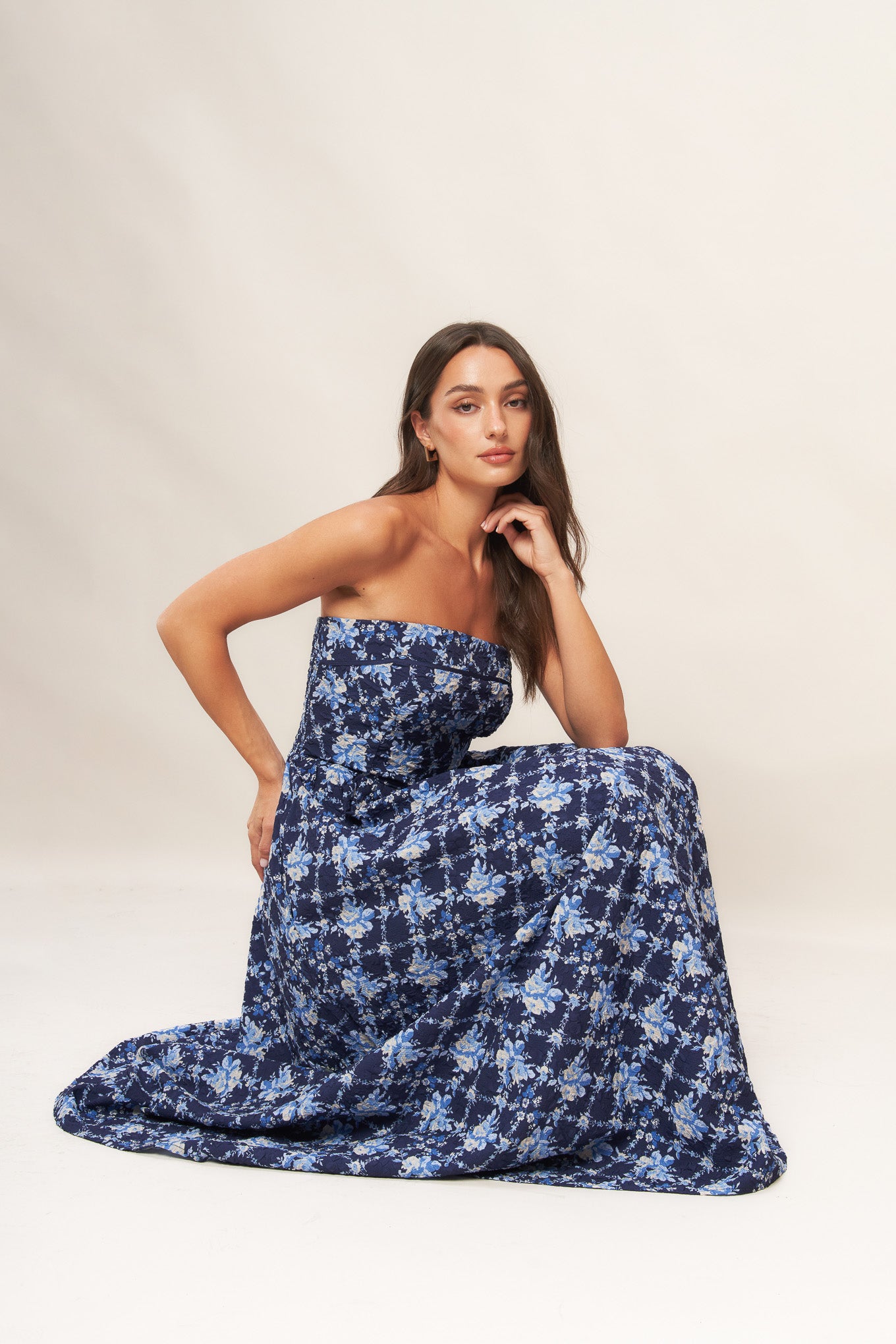 A textured woven midi dress featuring strapless, full skirt and smocked back bodices