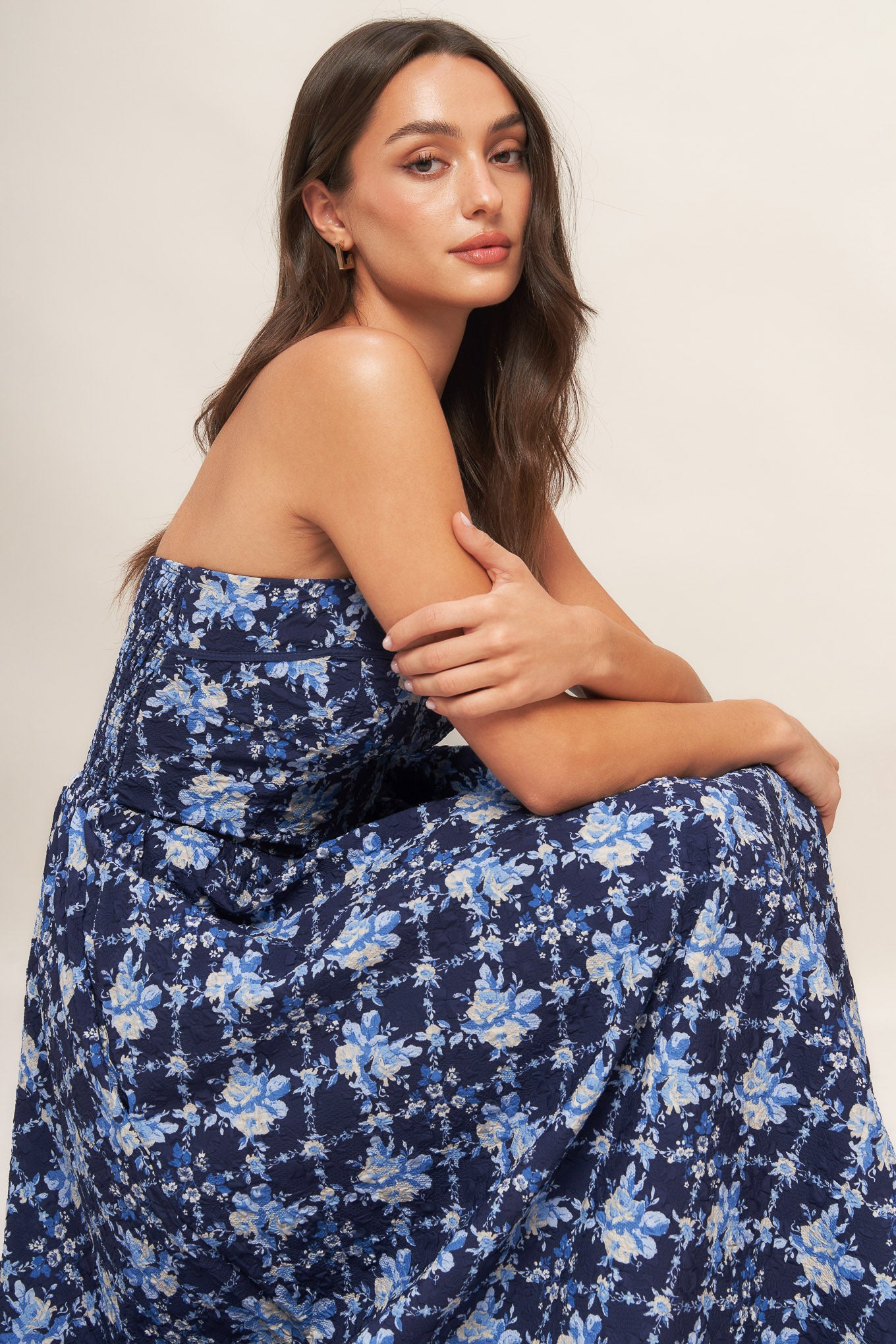 A textured woven midi dress featuring strapless, full skirt and smocked back bodices