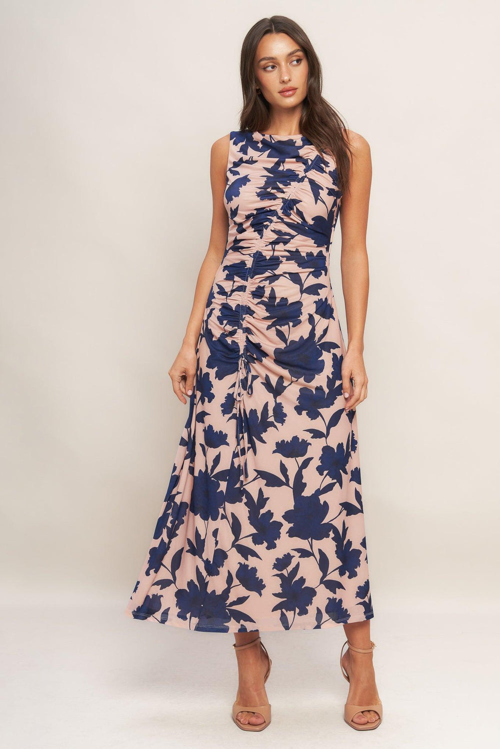 A printed power mesh midi dress featuring boat neckline, sleeveless, shirred body and back zipper closure