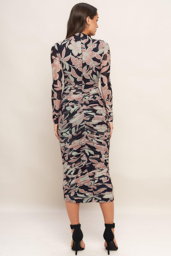 A printed power mesh midi dress featuring body contouring, long sleeve, shirred side and back zipper closure
