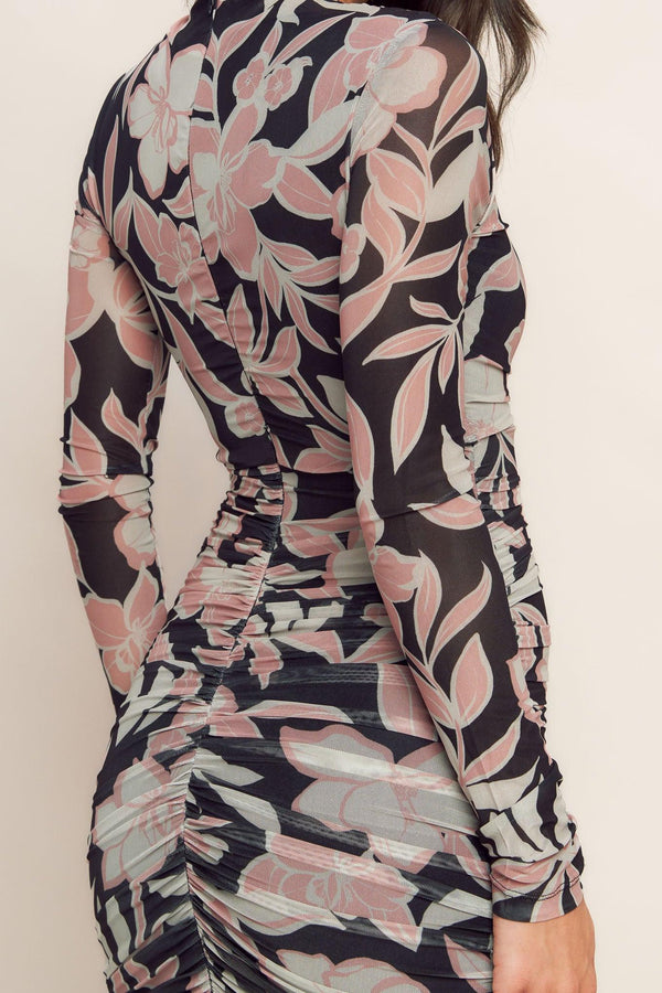 A printed power mesh midi dress featuring body contouring, long sleeve, shirred side and back zipper closure