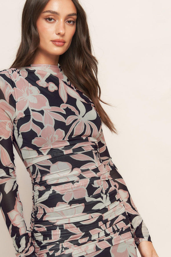 A printed power mesh midi dress featuring body contouring, long sleeve, shirred side and back zipper closure