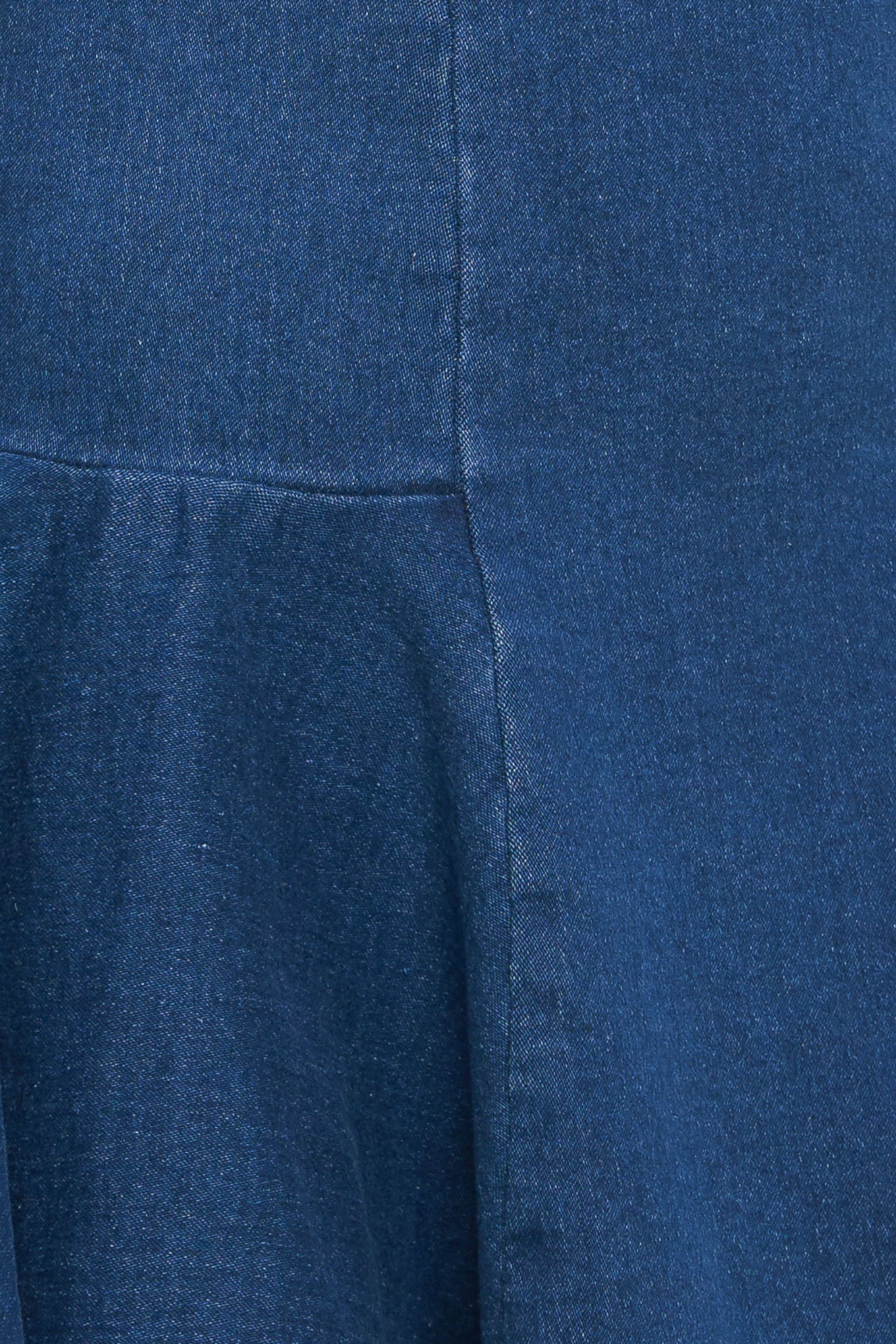 A washed denim mini dress featuring square neckline, sleeveless, body contouring with circle hem and back zipper closure