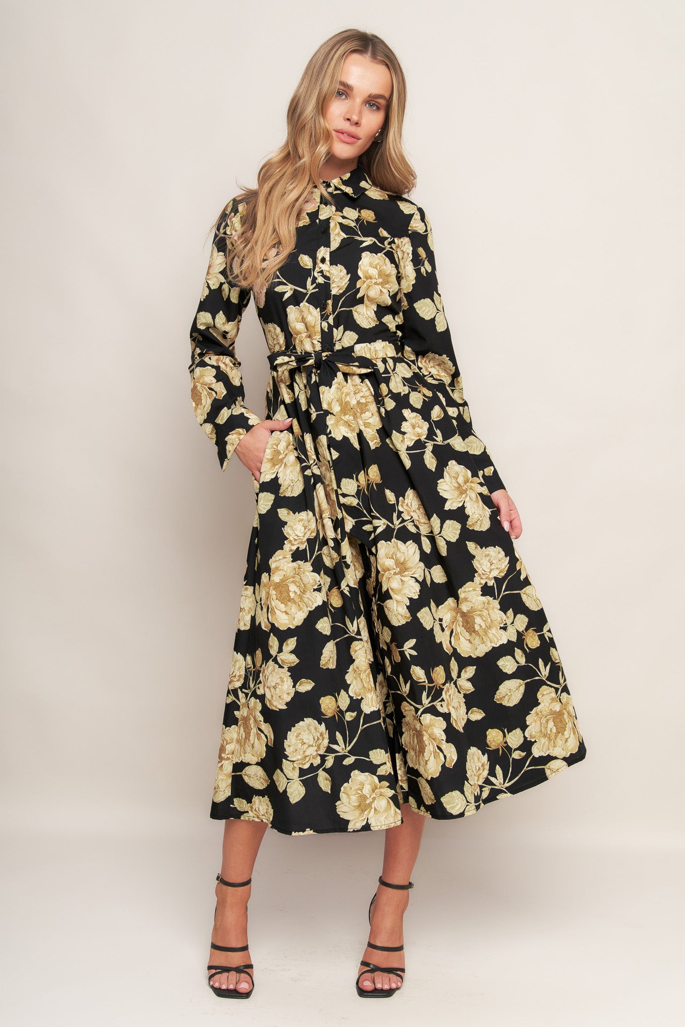 A printed woven midi dress featuring collar, long sleeve, front button down, self sash and full skirt