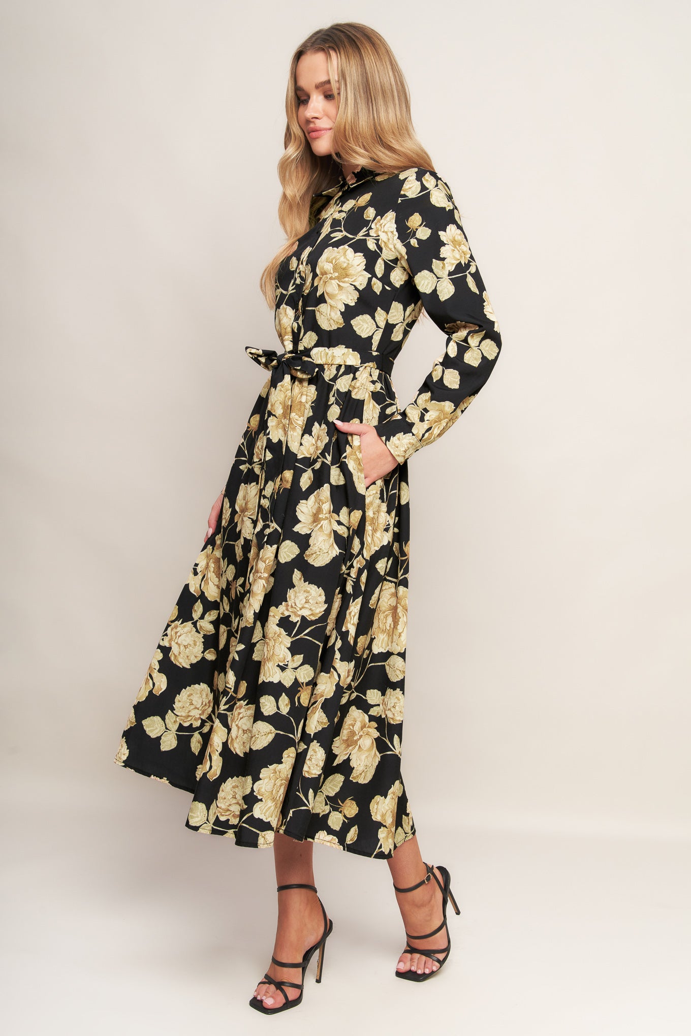 A printed woven midi dress featuring collar, long sleeve, front button down, self sash and full skirt